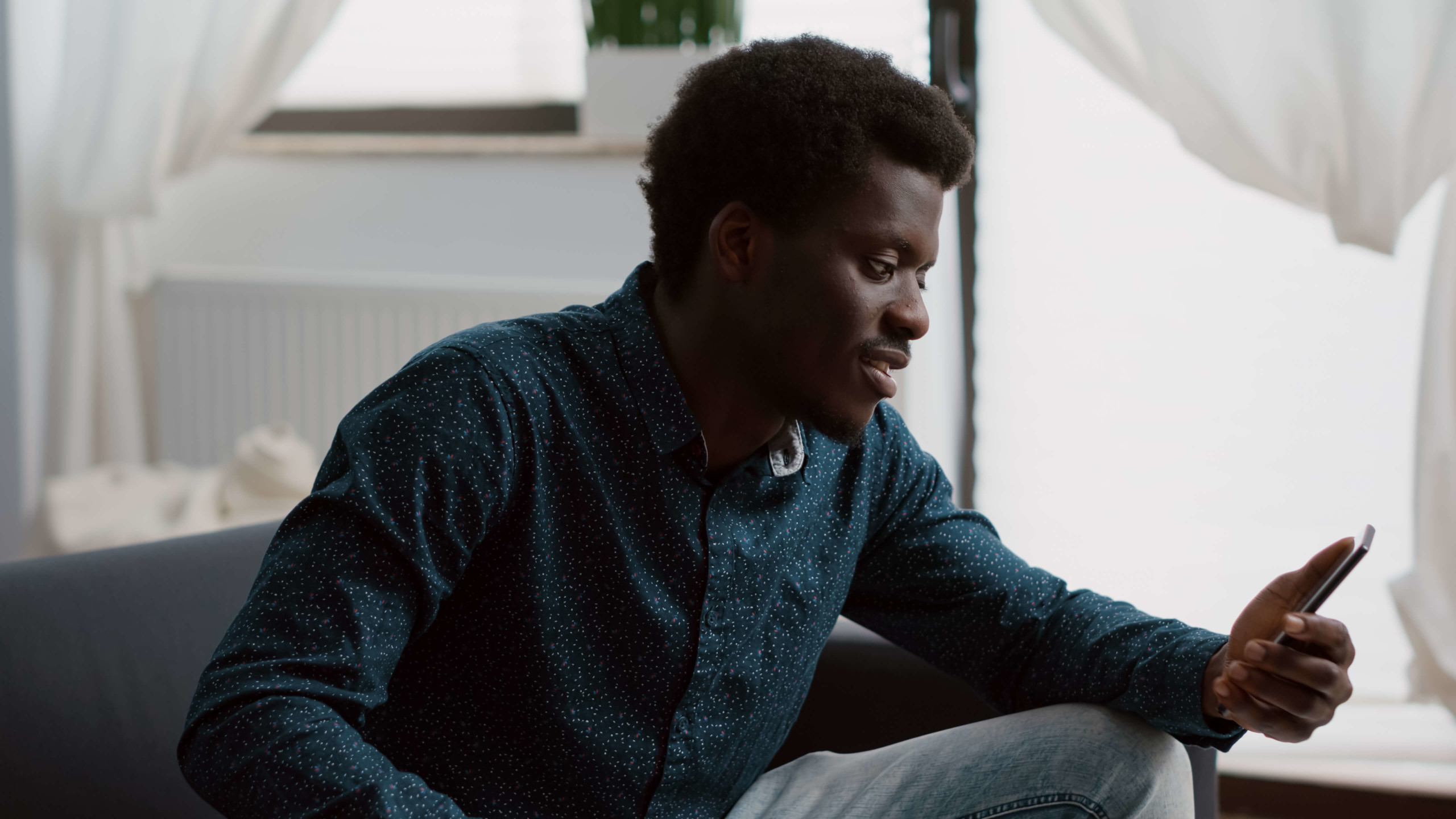 Young man with smartphone confirming liveness